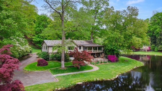 a view of a house with a yard and a garden
