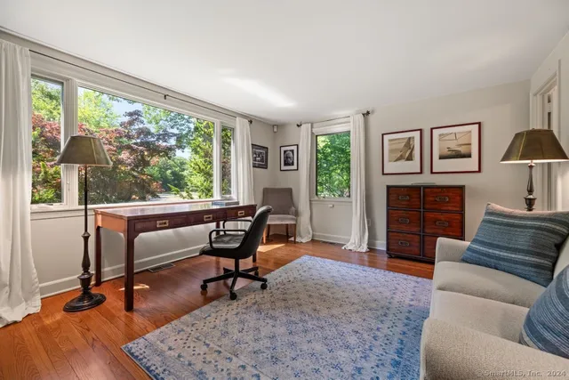a view of a livingroom with workspace and a couch
