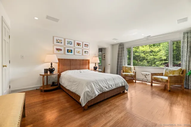 a bedroom with a large bed and a large window