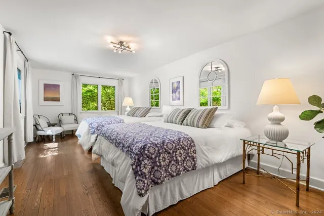 a spacious bedroom with a bed and a chandelier
