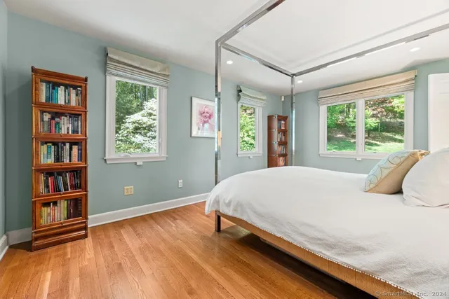 a bedroom with a large bed and a book shelf
