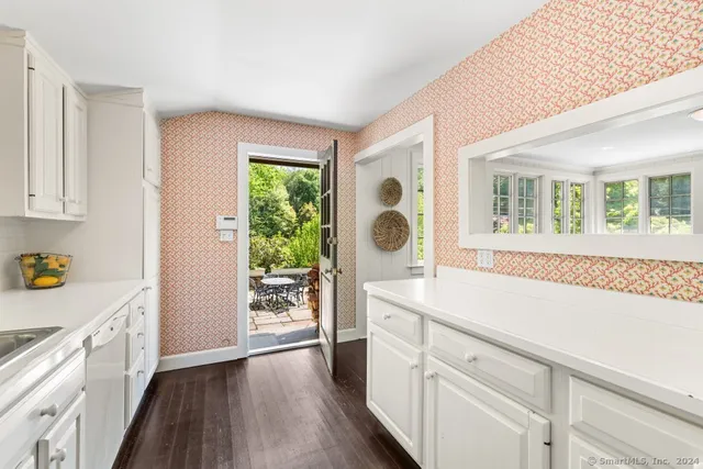 a kitchen with a refrigerator and a sink