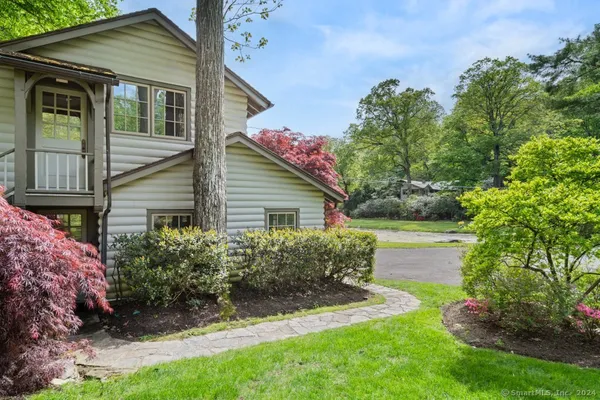 a view of backyard of house with green space