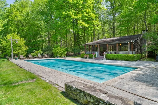 a front view of a house with a yard and green space