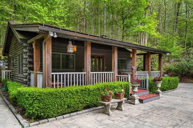 a view of a chair and table in the back yard of the house