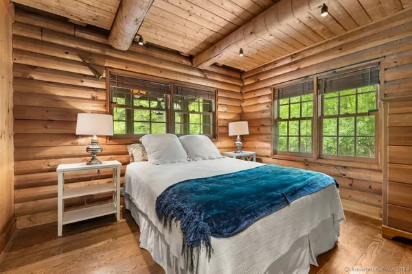 a bed sitting in a bedroom next to a window