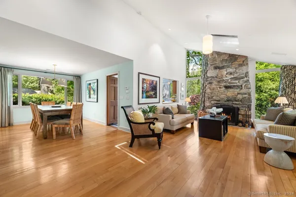 a living room with fireplace furniture and a wooden floor