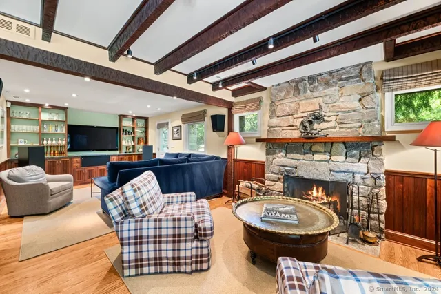 a living room with furniture a rug and a fireplace