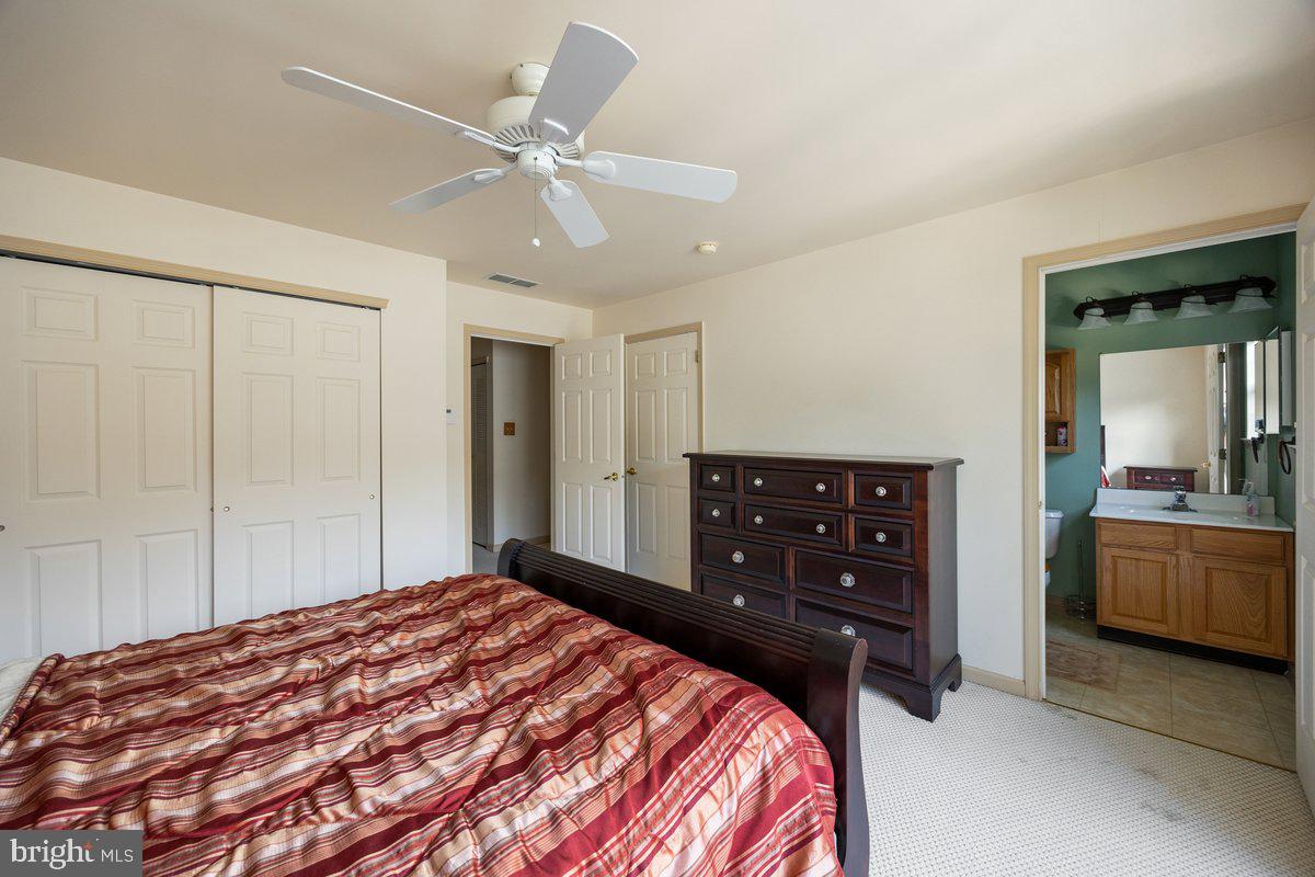 18 Alexandra Court Marlton, NJ 08053 - Photo 16 of 24 a bedroom with a bed and a chandelier