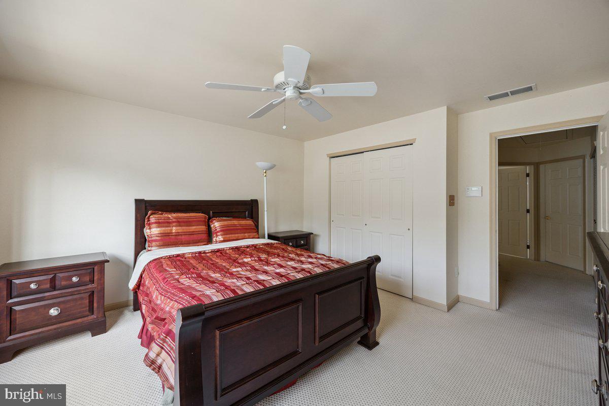 18 Alexandra Court Marlton, NJ 08053 - Photo 17 of 24 a bedroom with a bed and a chandelier