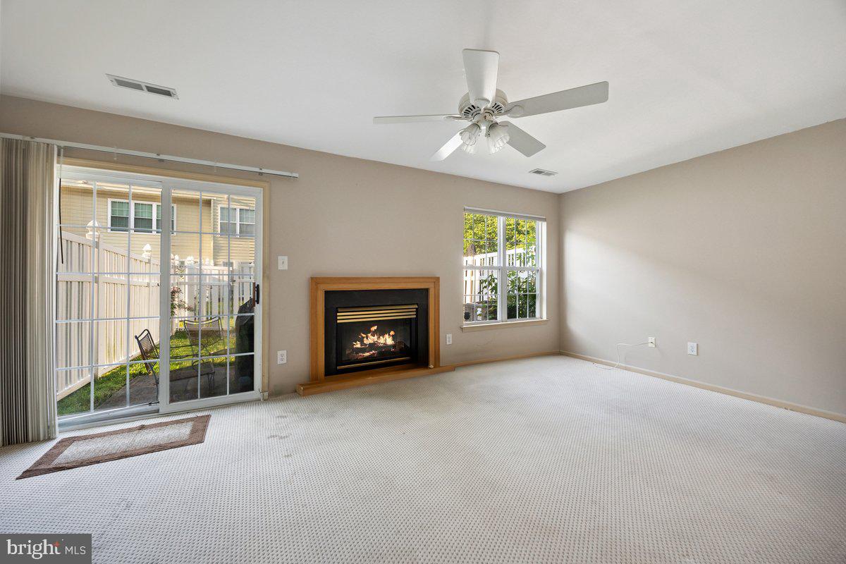18 Alexandra Court Marlton, NJ 08053 - Photo 4 of 24 an empty room with windows fireplace and fan