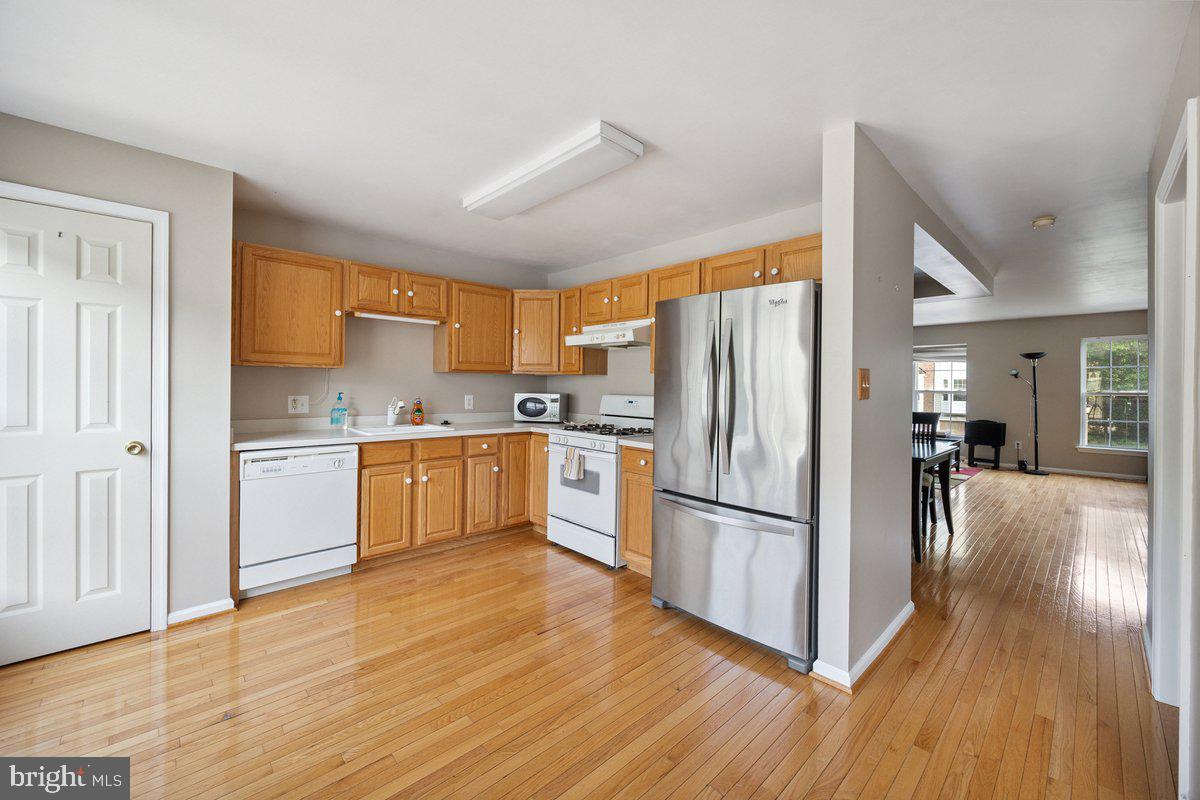 18 Alexandra Court Marlton, NJ 08053 - Photo 9 of 24 a kitchen with wooden floors stainless steel appliances and cabinets