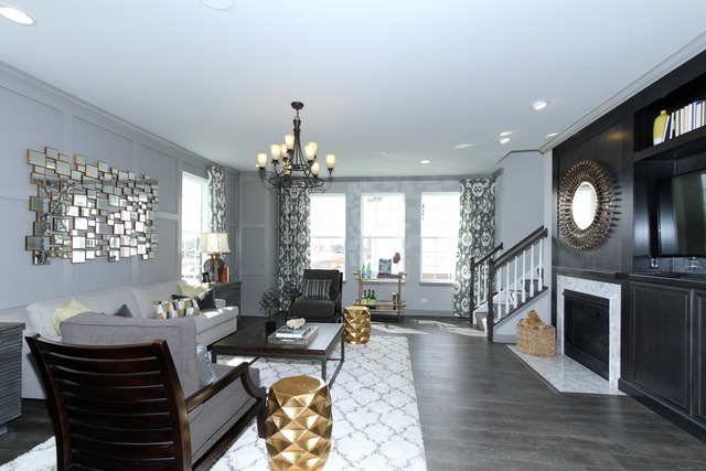 21 Marcel Lane Schaumburg, IL 60194 - Photo 3 of 22 a living room with furniture a fireplace and a chandelier