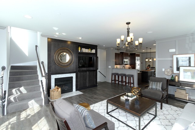 21 Marcel Lane Schaumburg, IL 60194 - Photo 5 of 22 a living room with furniture a fireplace and a chandelier