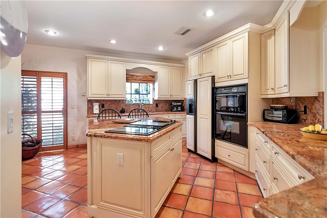 6396 Via Rosa Boca Raton, FL 33433 - Photo 11 of 30 a kitchen with stainless steel appliances granite countertop a refrigerator a sink dishwasher and white cabinets with wooden floor