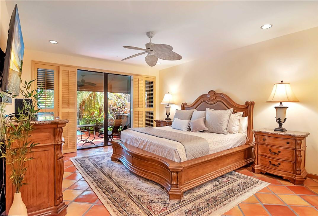 6396 Via Rosa Boca Raton, FL 33433 - Photo 16 of 30 a bedroom with a bed and wooden floor