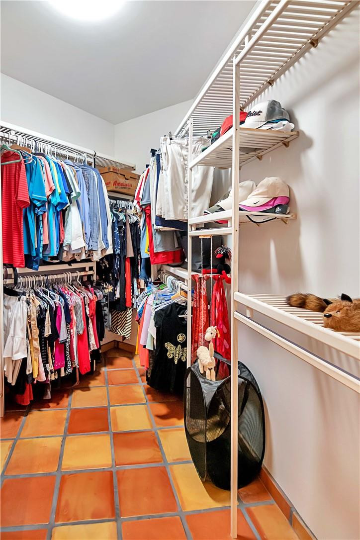 6396 Via Rosa Boca Raton, FL 33433 - Photo 20 of 30 a view of walk in closet with clothes and shoes