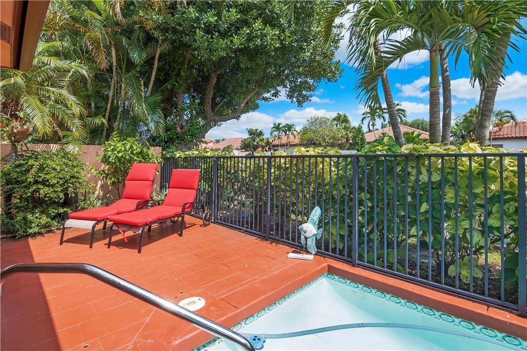 6396 Via Rosa Boca Raton, FL 33433 - Photo 24 of 30 a swimming pool with lawn chairs and wooden fence