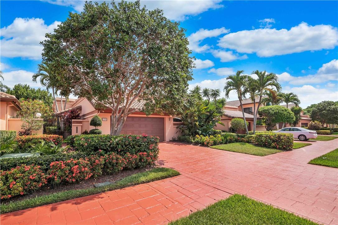 6396 Via Rosa Boca Raton, FL 33433 - Photo 27 of 30 a front view of a house with a yard and fountain in middle