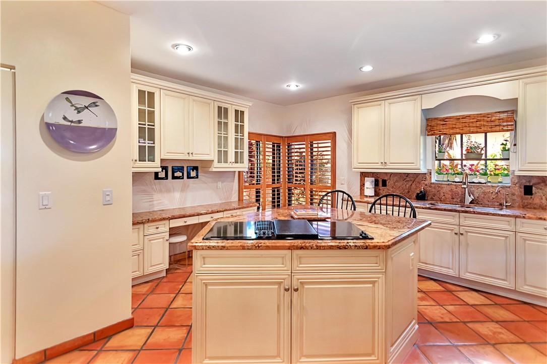6396 Via Rosa Boca Raton, FL 33433 - Photo 9 of 30 a kitchen with kitchen island granite countertop a sink and a refrigerator