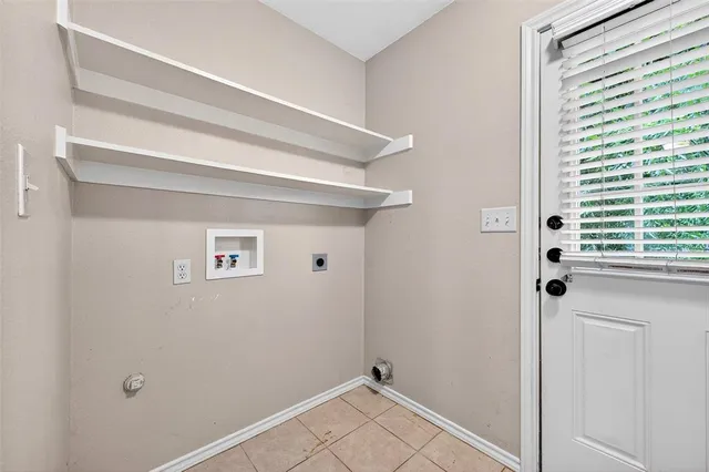 a view of a room that has a window and wooden floor