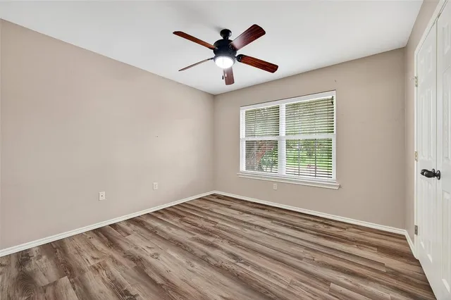 wooden floor in an empty room with a window