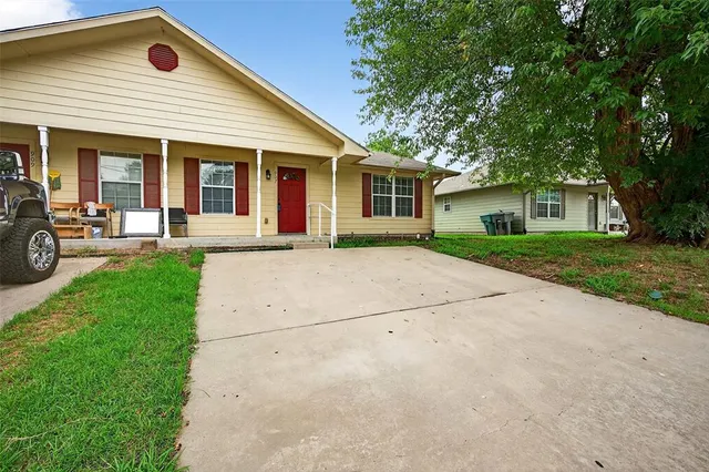 a front view of house with yard and outdoor seating