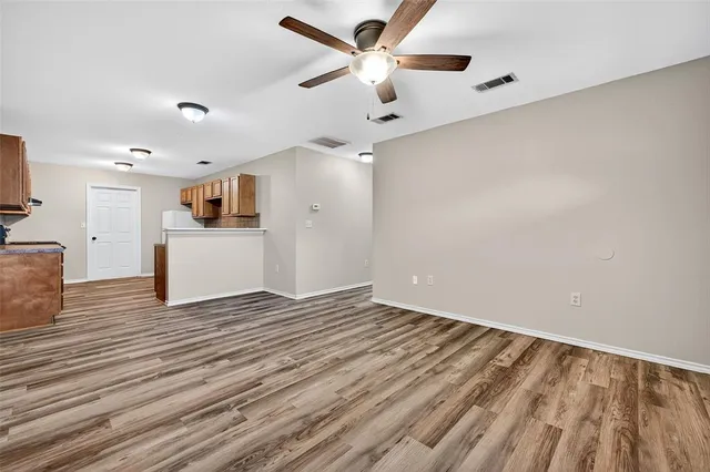 a view of a kitchen with a dishwasher and wooden floor