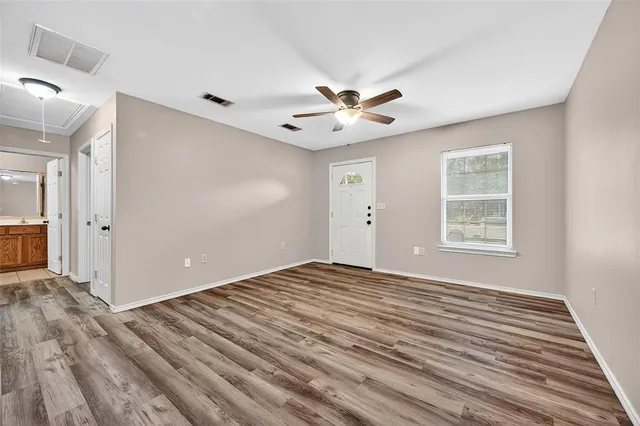 wooden floor in an empty room with a window