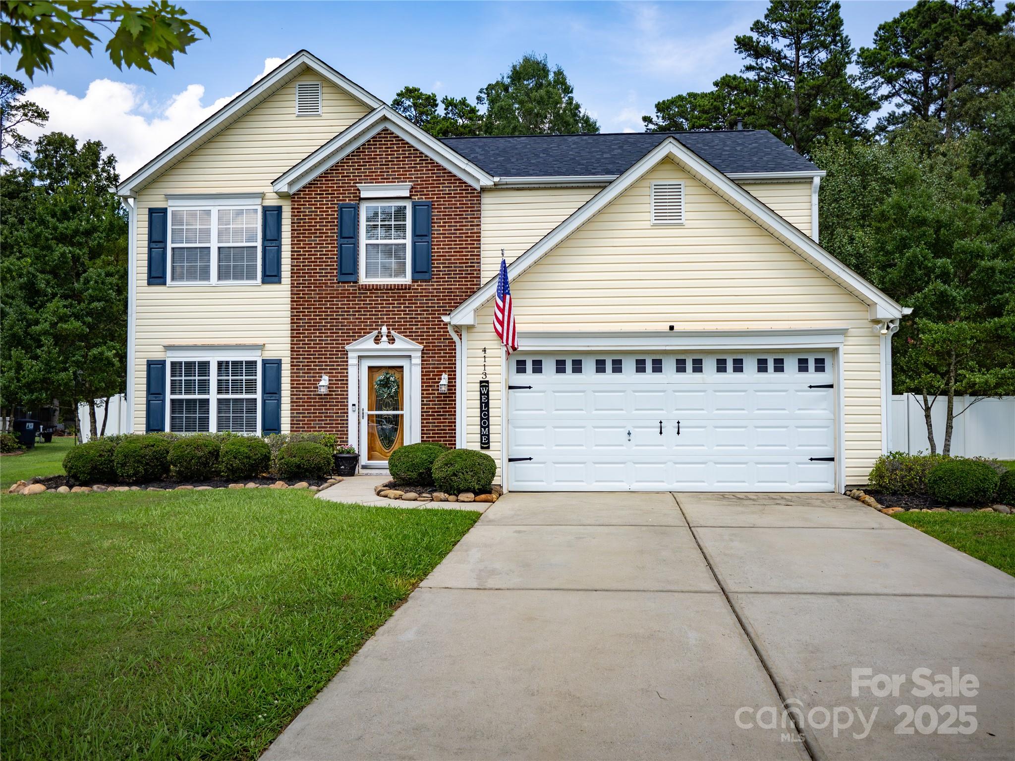 a view of house with yard and green space