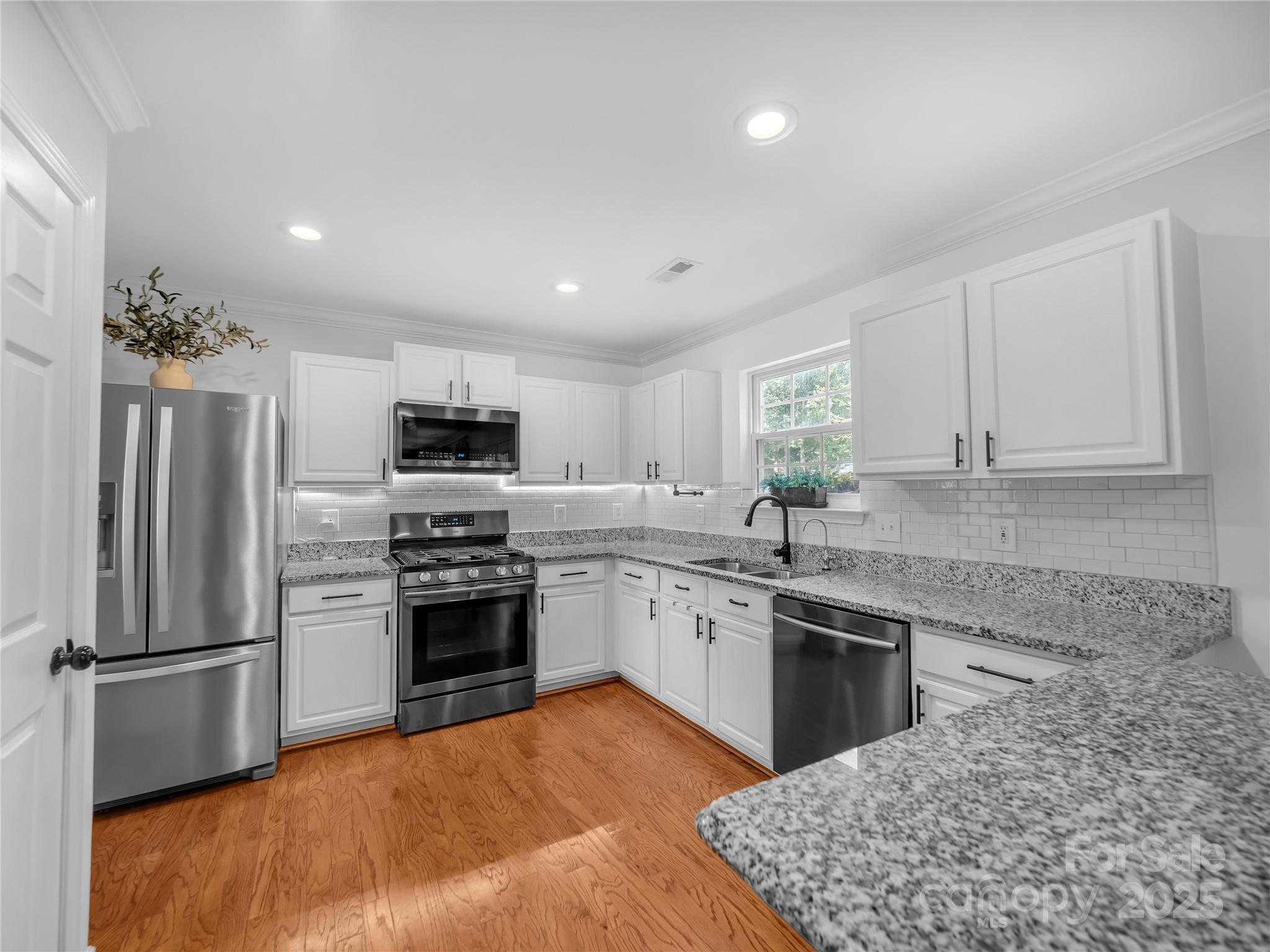 4113 Edgeview Drive Indian Trail, NC 28079 - Photo 4 of 28 a kitchen with granite countertop stainless steel appliances and wooden cabinets