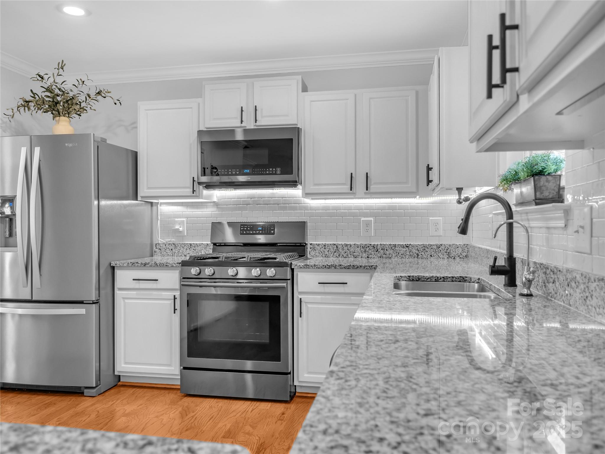 4113 Edgeview Drive Indian Trail, NC 28079 - Photo 5 of 28 a kitchen with stainless steel appliances granite countertop a stove a refrigerator and a sink
