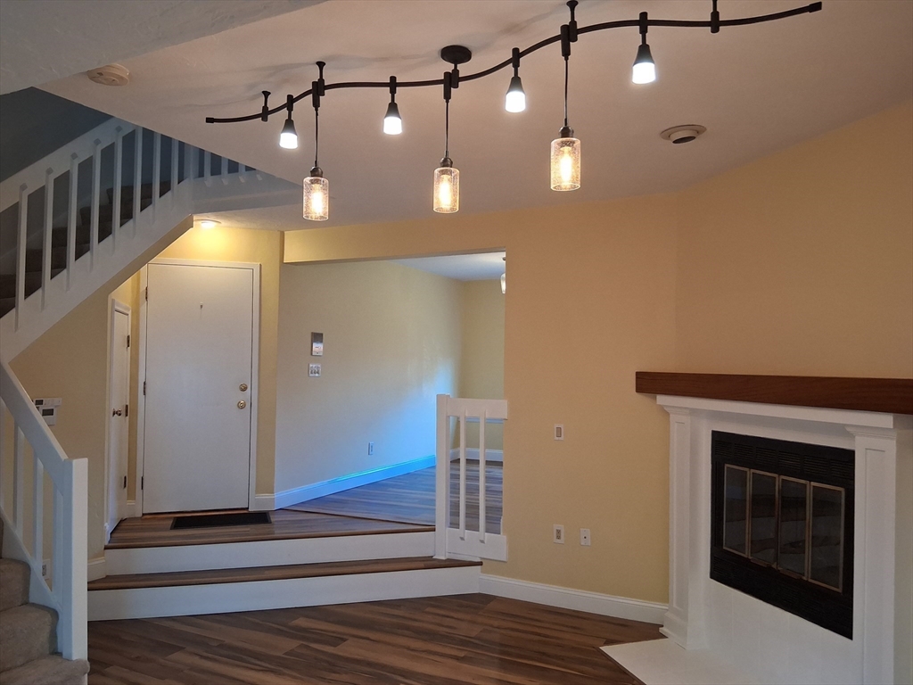 191 Tall Oaks Drive, Unit C Weymouth, MA 02190 - Photo 14 of 24 a view of a livingroom with a fireplace and wooden floor