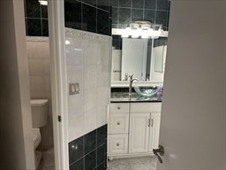 191 Tall Oaks Drive, Unit C Weymouth, MA 02190 - Photo 15 of 24 a bathroom with a granite countertop sink and mirror