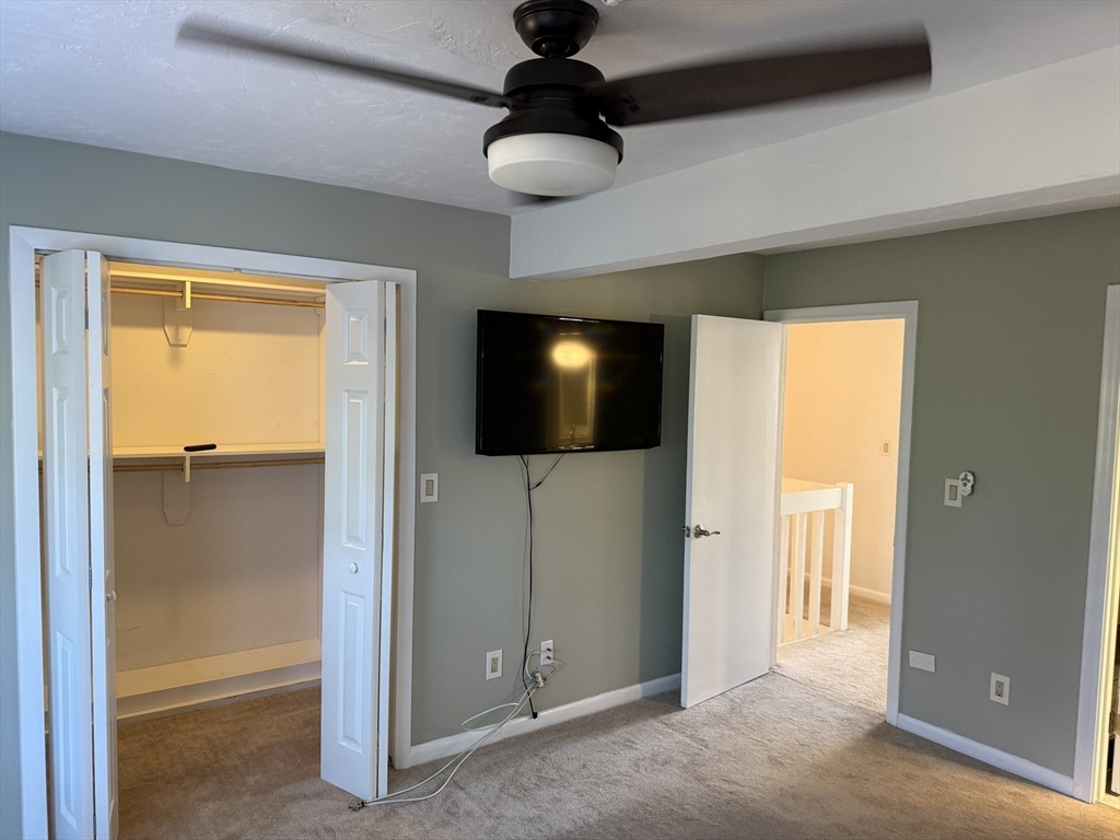 191 Tall Oaks Drive, Unit C Weymouth, MA 02190 - Photo 18 of 24 a living room with furniture and a flat screen tv