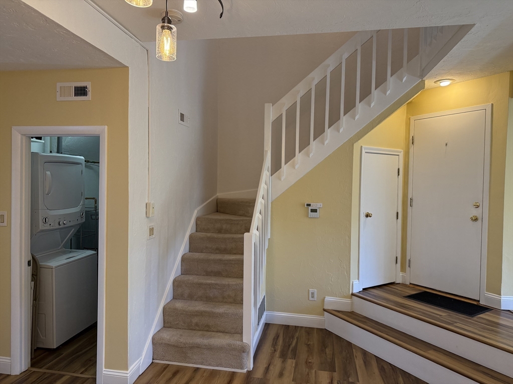 191 Tall Oaks Drive, Unit C Weymouth, MA 02190 - Photo 20 of 24 a view of a hallway with wooden floor and staircase