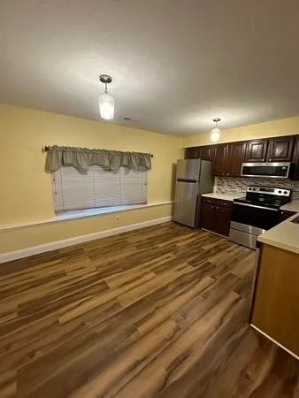 a view of kitchen and wooden floor