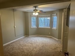 191 Tall Oaks Drive, Unit C Weymouth, MA 02190 - Photo 7 of 24 a view of an empty room with window and chandelier fan