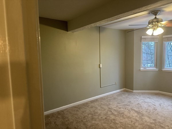 191 Tall Oaks Drive, Unit C Weymouth, MA 02190 - Photo 9 of 24 a view of an empty room with a chandelier fan