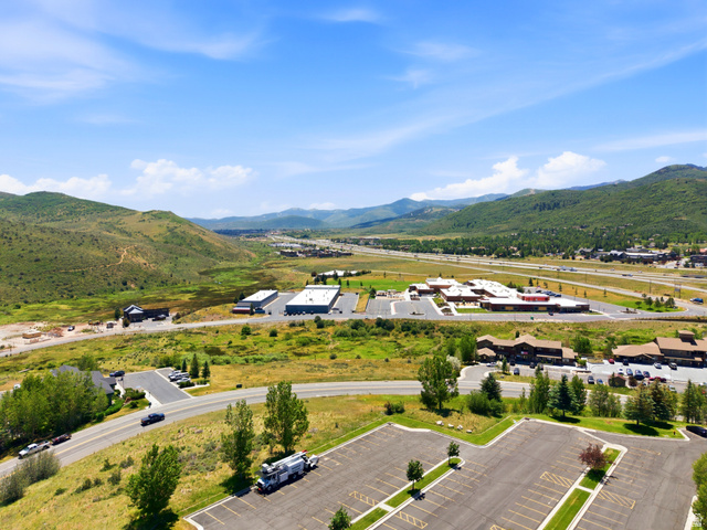 3148 Lower Saddleback Road Park City, UT 84098 - Photo 64 of 67 Expansive mountainous landscape featuring multiple commercial buildings with paved parking areas and a multi-lane highway