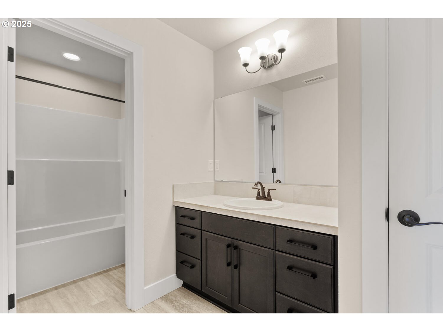1100 North 44th Place Ridgefield, WA 98642 - Photo 21 of 29 a bathroom with a double vanity sink a mirror and a bathtub