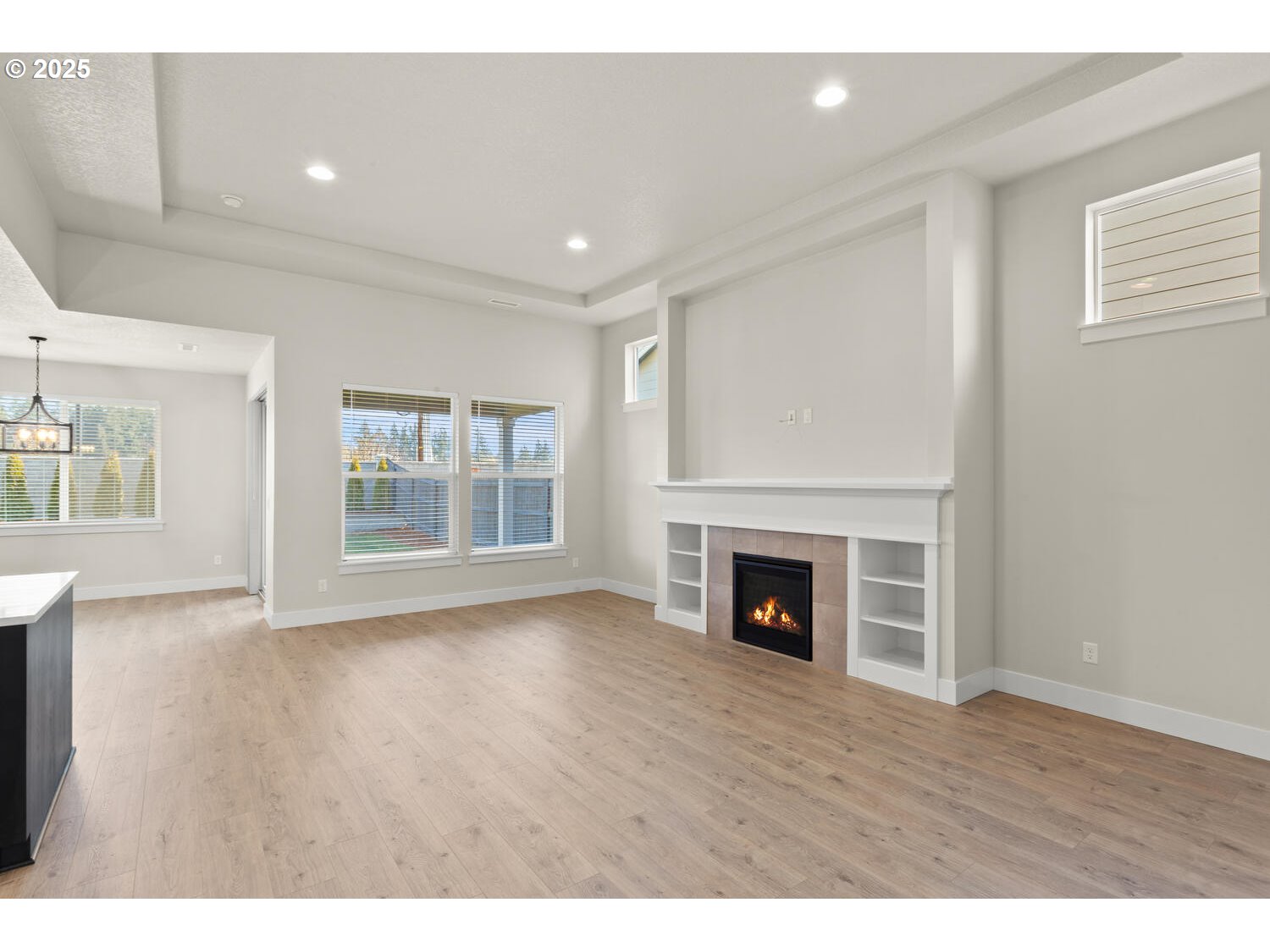 1100 North 44th Place Ridgefield, WA 98642 - Photo 6 of 29 a view of an empty room with wooden floor fireplace and a window