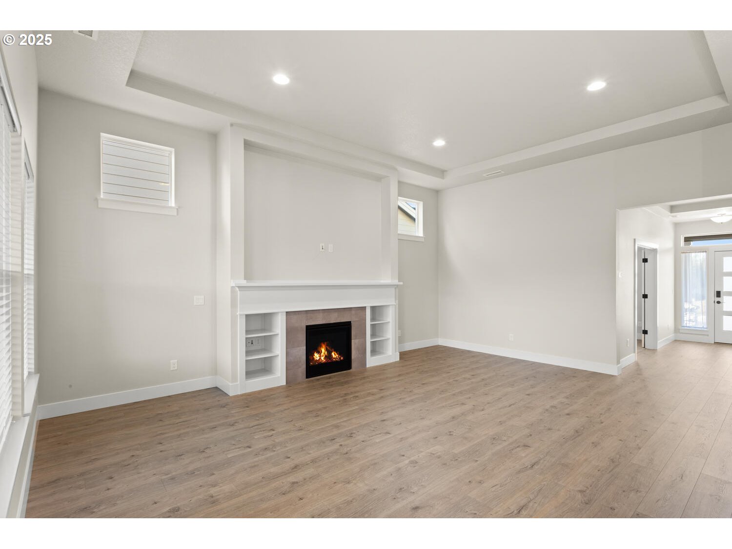 1100 North 44th Place Ridgefield, WA 98642 - Photo 7 of 29 a view of an empty room with wooden floor fireplace and a window