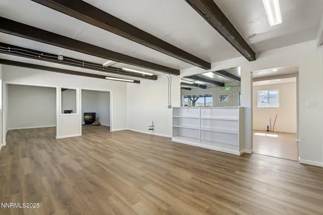 a view of an empty room and wooden floor