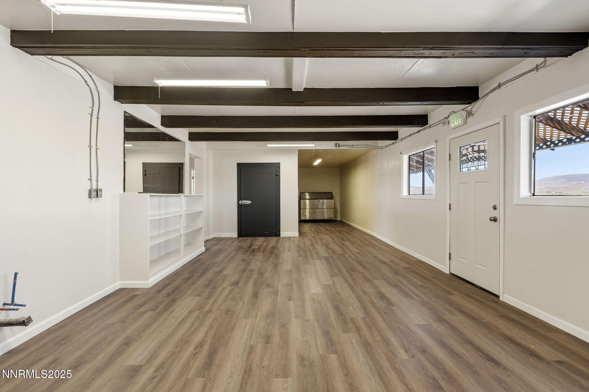 2725 East Fir Street Silver Springs, NV 89429 - Photo 21 of 56 a view of a hallway with wooden floor and staircase