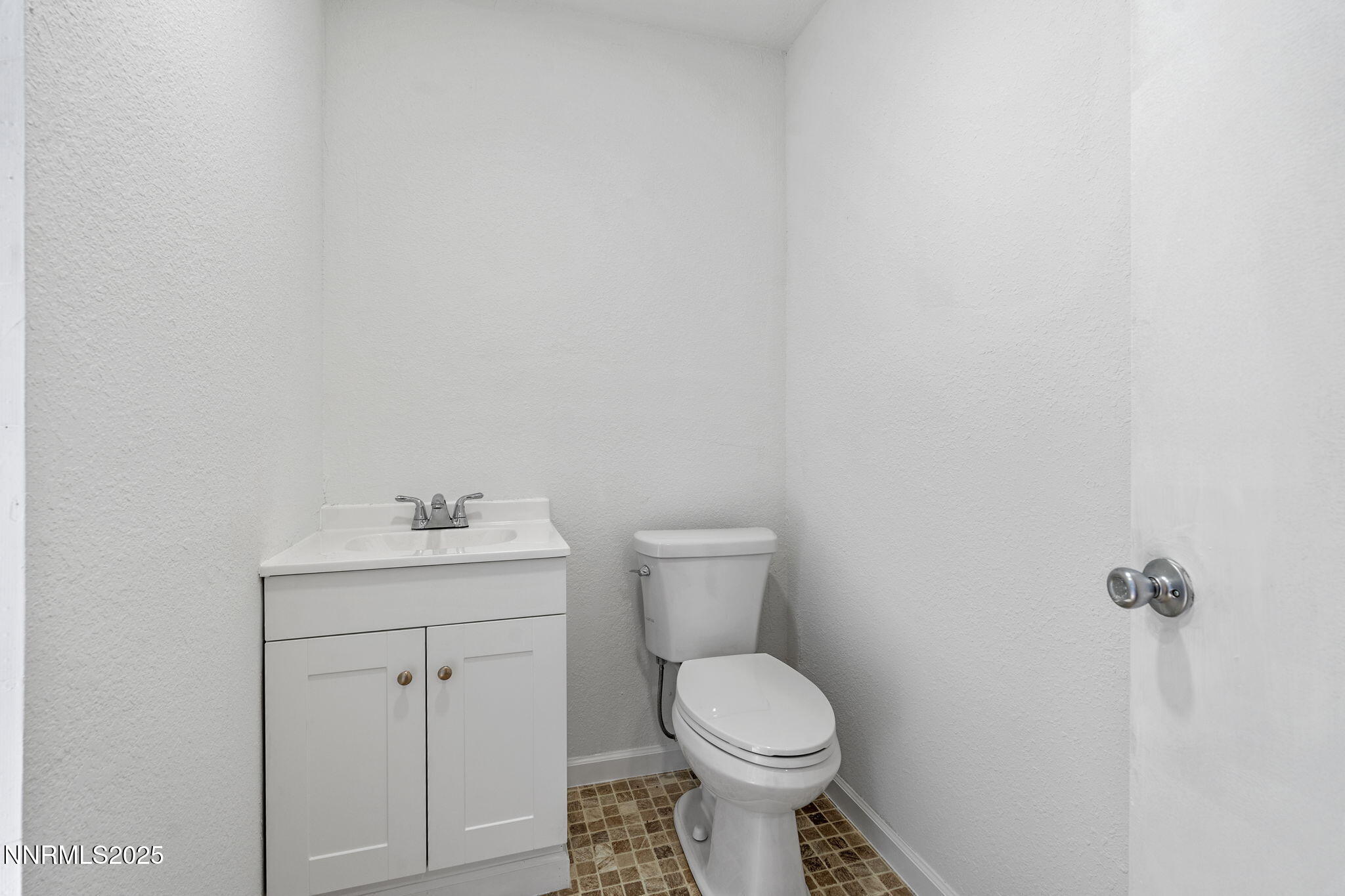 2725 East Fir Street Silver Springs, NV 89429 - Photo 24 of 56 a white toilet sitting next to a bathroom sink