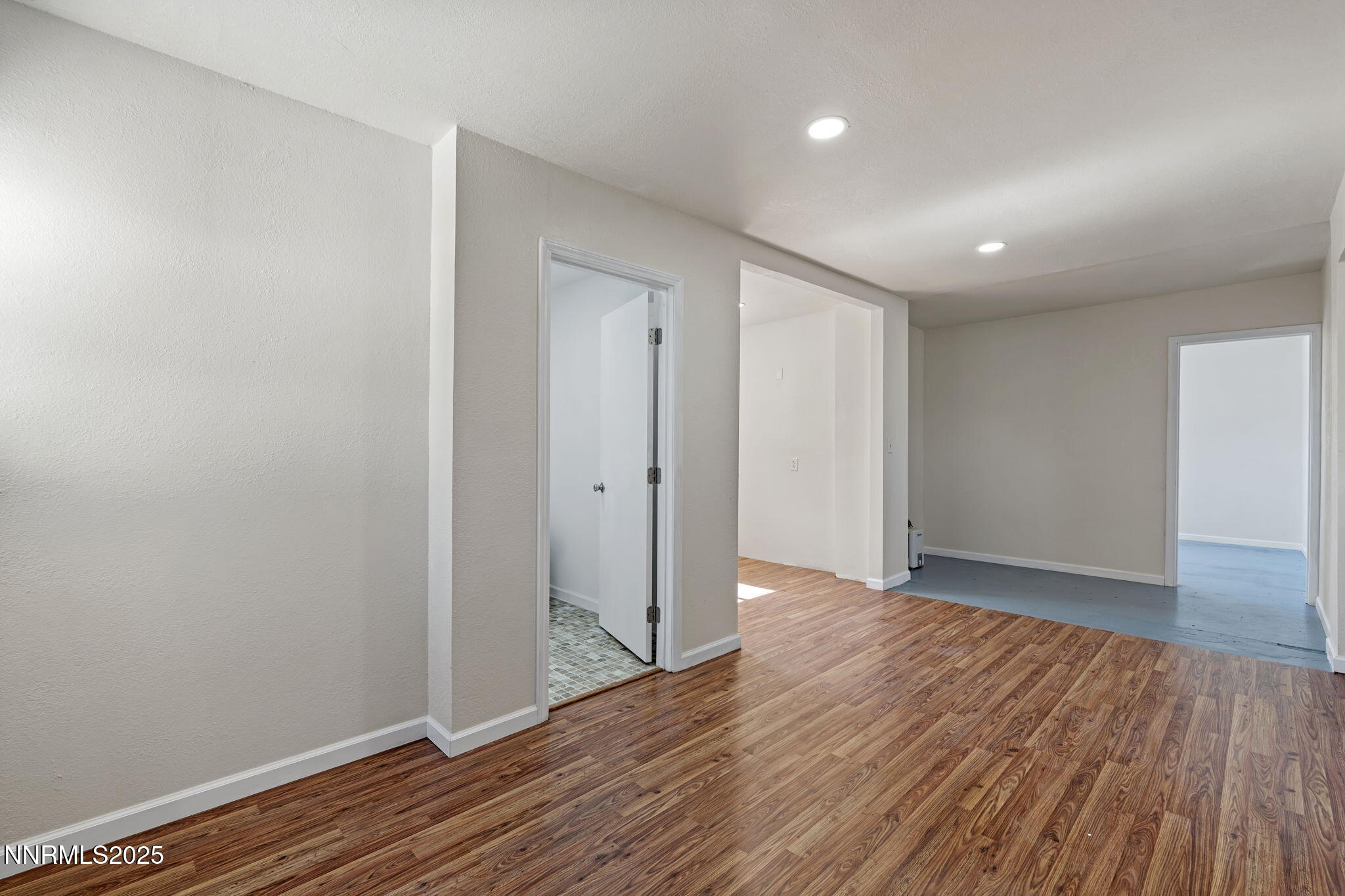 2725 East Fir Street Silver Springs, NV 89429 - Photo 27 of 56 a view of an empty room with wooden floor