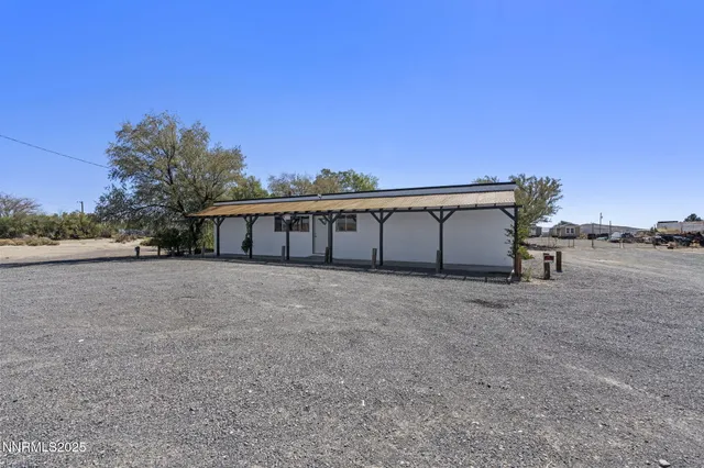 a view of a big room with a big yard and large trees