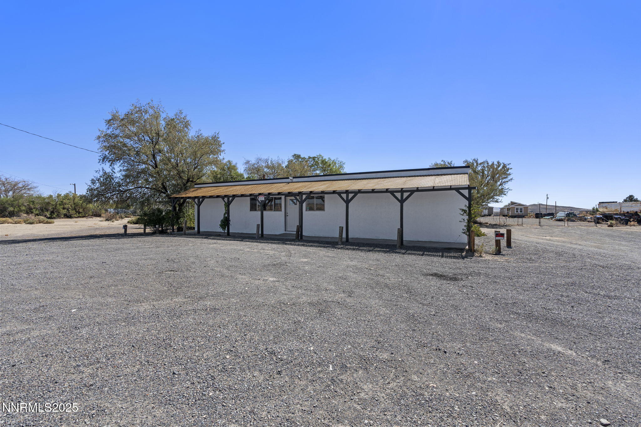 2725 East Fir Street Silver Springs, NV 89429 - Photo 3 of 56 a view of a big room with a big yard and large trees