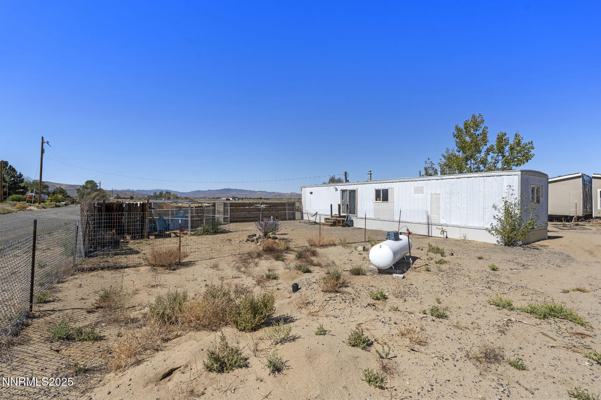 2725 East Fir Street Silver Springs, NV 89429 - Photo 40 of 56 a view of a dry yard with chairs